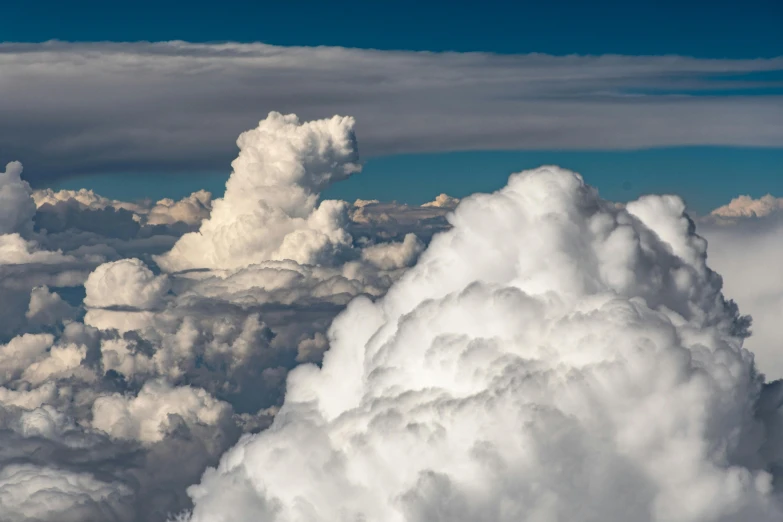 a blue sky filled with lots of white clouds, by Daniel Seghers, unsplash, towering cumulonimbus clouds, seen from a plane, slide show, high details photo