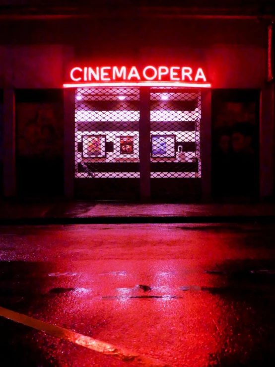 a red neon sign on the side of a building, an album cover, inspired by Elsa Bleda, unsplash, hyperrealism, photo of the cinema screen, opera, 💋 💄 👠 👗, cinémascope