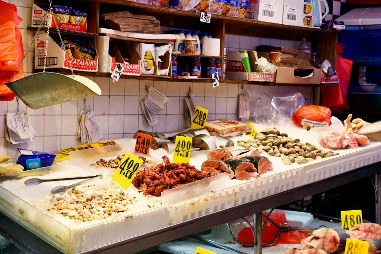 a counter topped with lots of different types of food, a photo, by Julia Pishtar, fish market stalls, featured, simone graci, brown