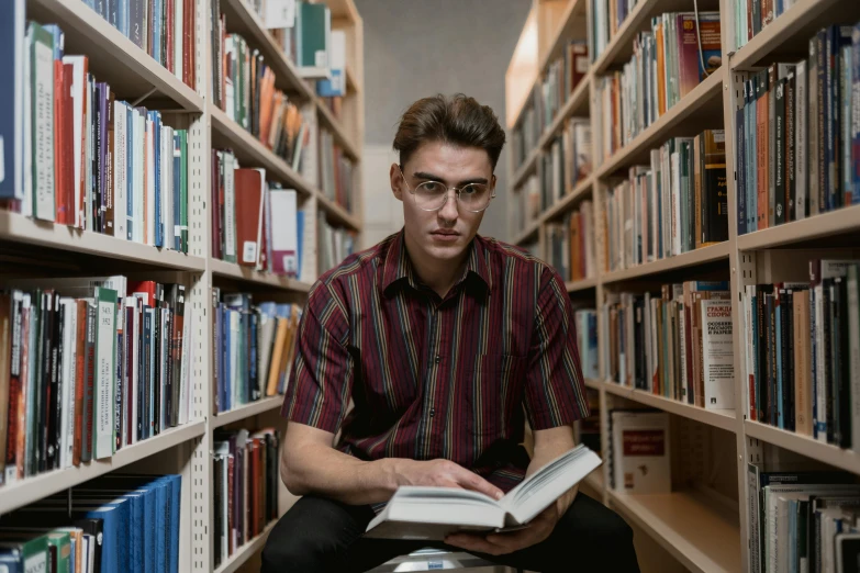 a man sitting in a library reading a book, a portrait, pexels contest winner, non binary model, avatar image, lachlan bailey, serious expression
