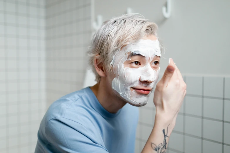 a man shaving his face with a facial mask, inspired by jeonseok lee, eva elfie, white facepaint, profile image, bottom angle