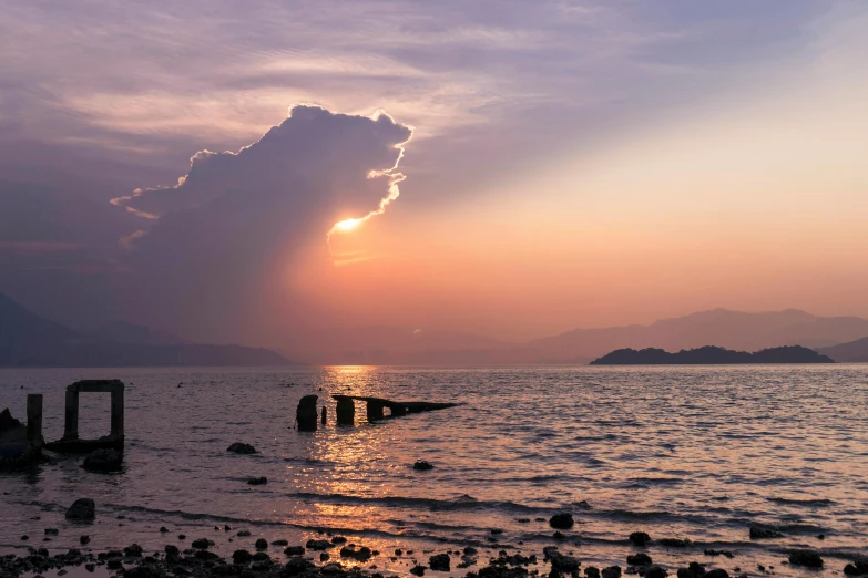 the sun is setting over a body of water, pexels contest winner, romanticism, guwahati, skye meaker, with dramatic sky, shoreline