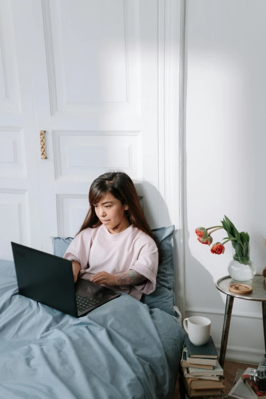 a little girl sitting on a bed with a laptop, pexels contest winner, young asian woman, sleek design, programming, extremely uncomfortable