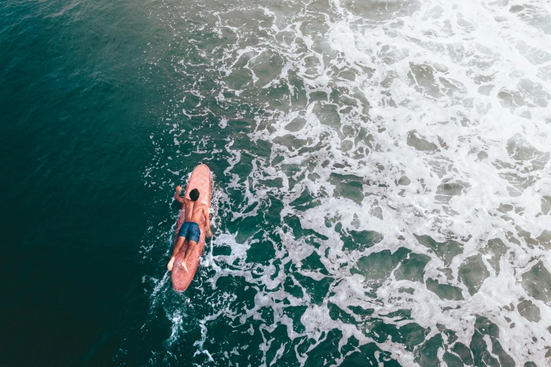 a man riding a surfboard on top of a wave, pexels contest winner, birdseye view, sunfaded, thumbnail, 1 2 9 7