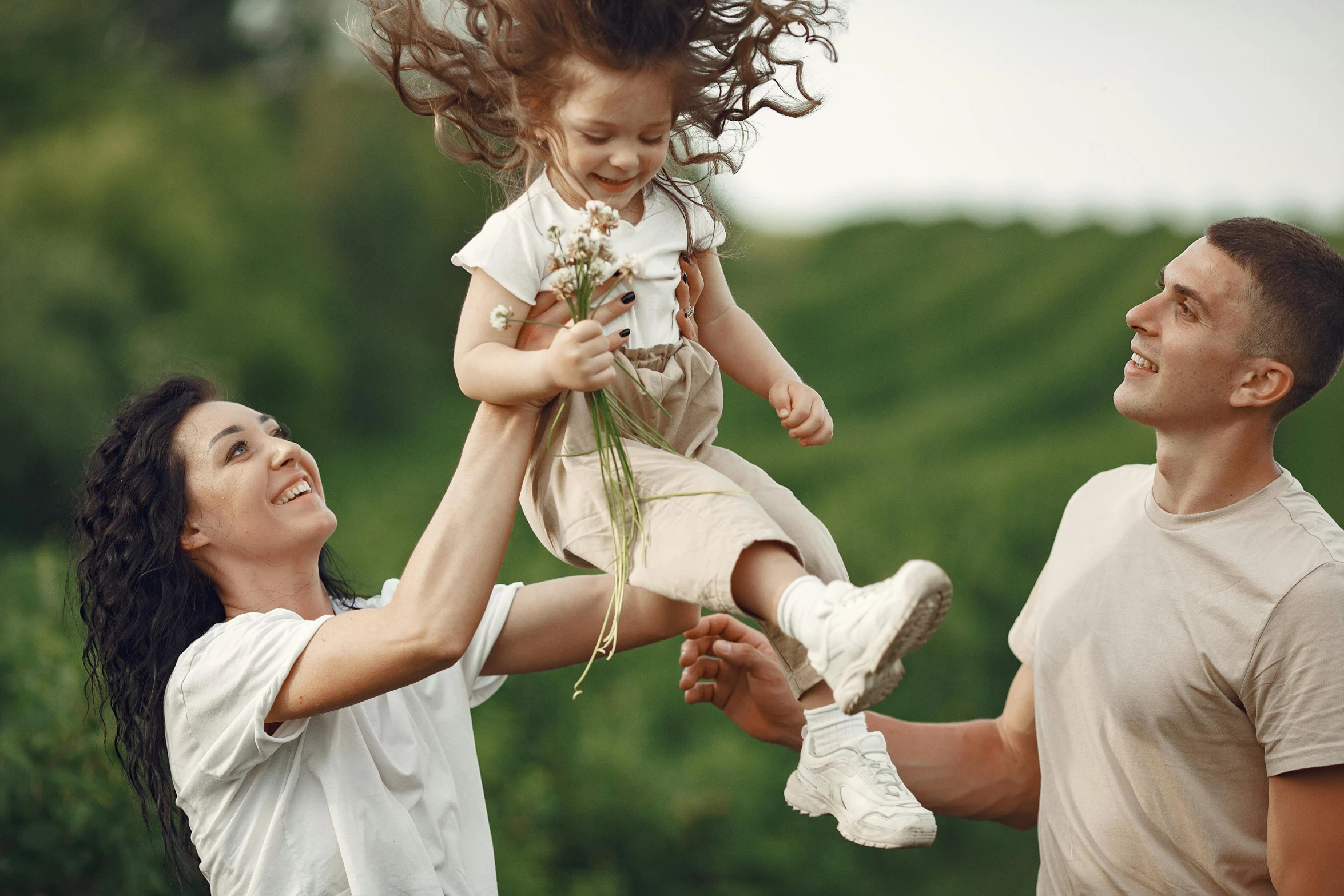 a man holding a little girl up in the air, pexels contest winner, renaissance, groups of happy humans, girl jumping in a flower field, husband wife and son, casual game