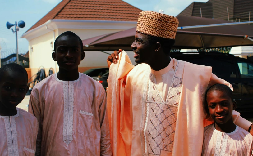 a group of men standing next to each other, pexels contest winner, les nabis, peach and goma style, father with child, robes, detailed with high quality