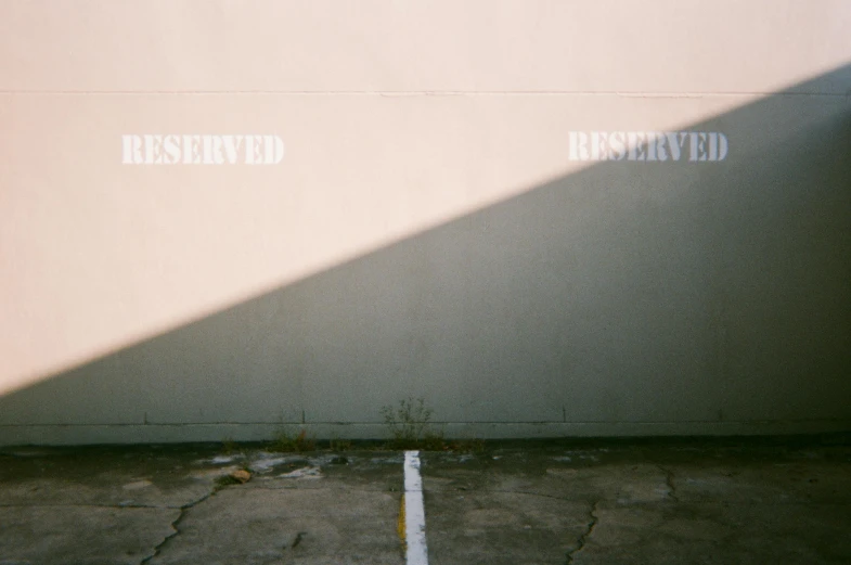 a fire hydrant sitting in the middle of a parking lot, an album cover, inspired by Elsa Bleda, unsplash, auto-destructive art, ignant, afternoon sunlight, concrete wall, ffffound