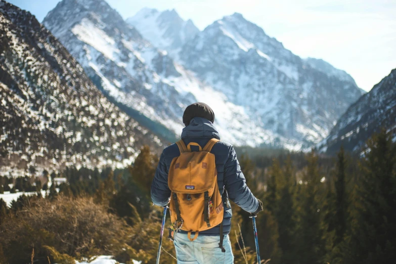 a man standing on top of a snow covered slope, pexels contest winner, with a backpack, avatar image, fall season, thumbnail