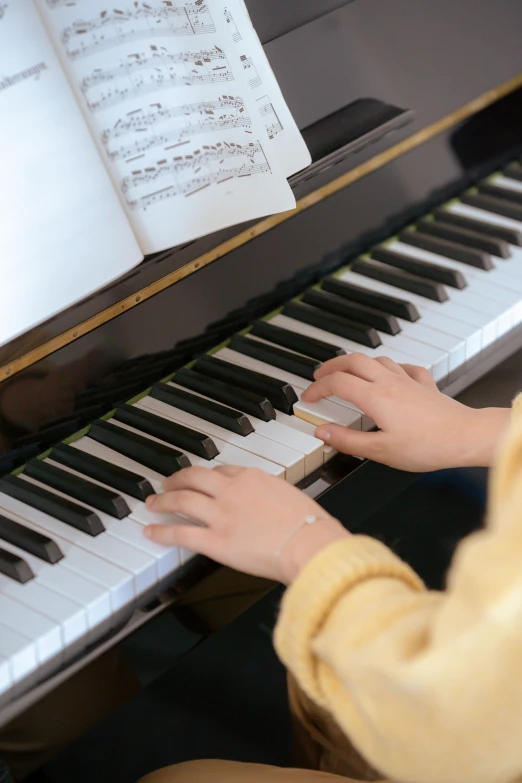 a close up of a person playing a piano, for junior, multiple stories, gongbi, premium quality