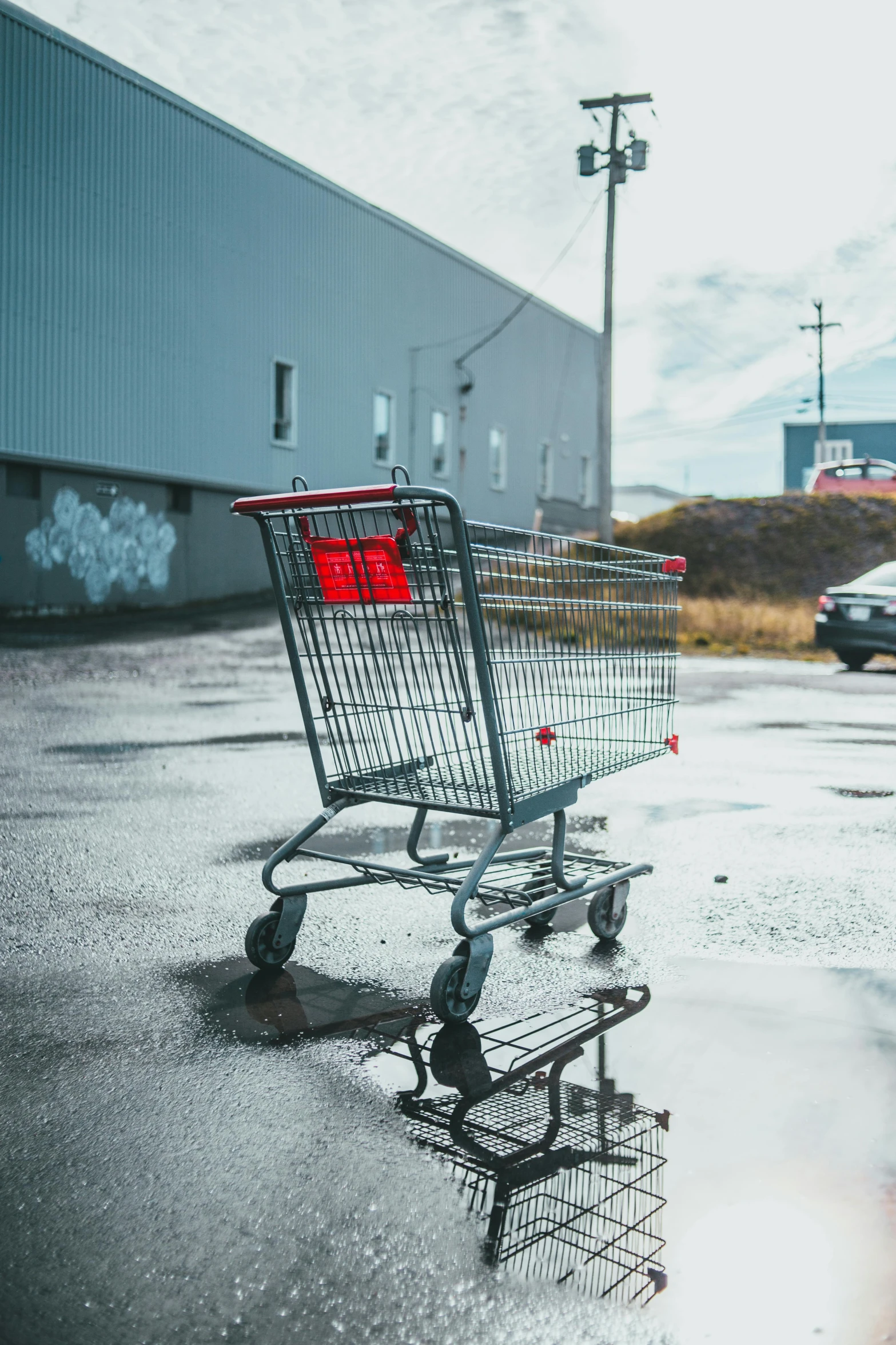 a shopping cart sitting in the middle of a parking lot, unsplash, hyperrealism, realistic », trending on r/streetwear, grey, crashcart