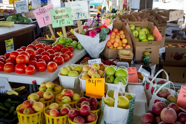 a farmers market filled with lots of fresh fruits and vegetables, square, apples, battered, image