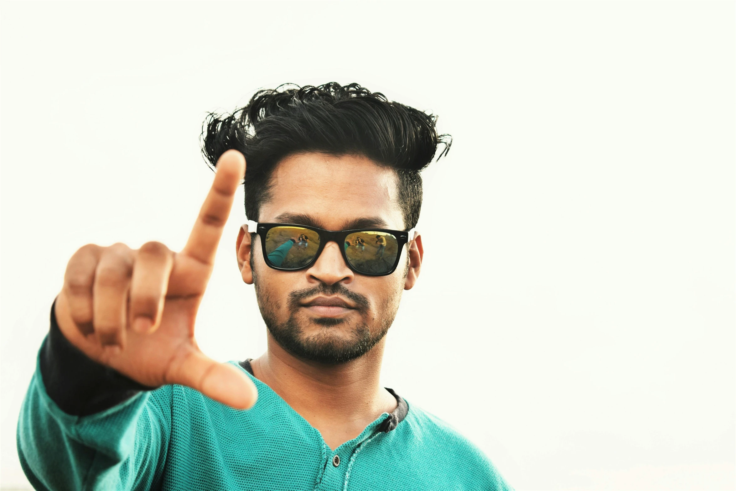 a close up of a person pointing a finger at the camera, inspired by Thota Vaikuntham, pexels contest winner, hurufiyya, cool tousled hair, wear ray - ban glass, profile image, 9 9 designs