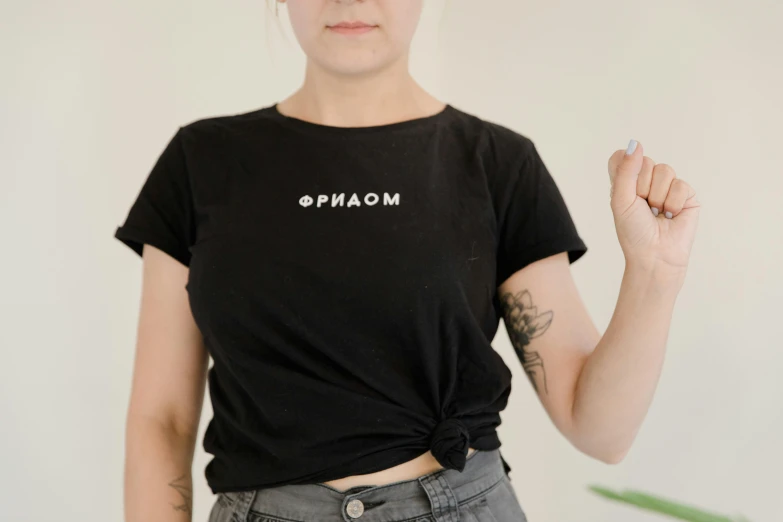 a woman holding a cigarette in one hand and a cigarette in the other, unsplash contest winner, orphism, wearing a black!! t - shirt, phasmophobia, embroidered shirt, product introduction photo