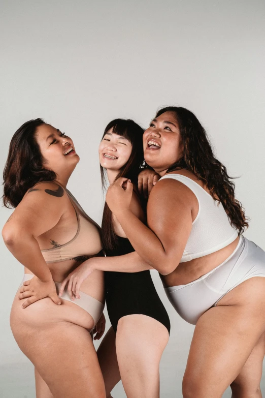 a group of women standing next to each other, silicone skin, plus-sized, playful pose, gemma chen