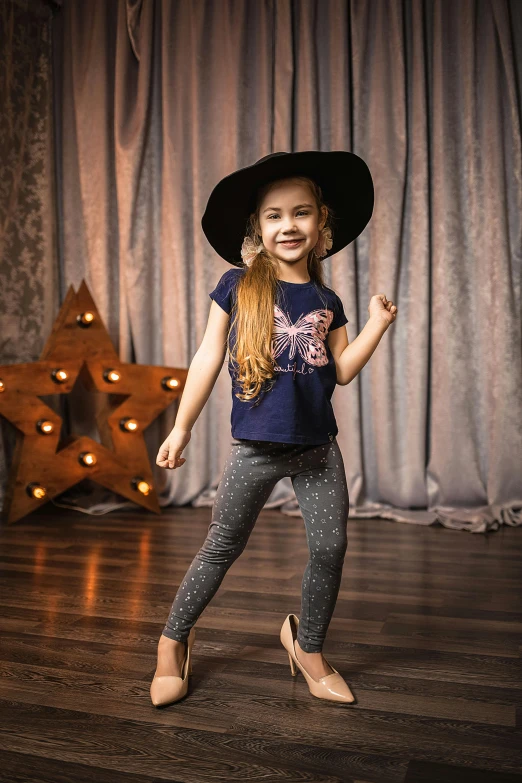 a little girl standing on top of a wooden floor, wearing a witch hat, jeans and t shirt, hollywood promotional image, paisley