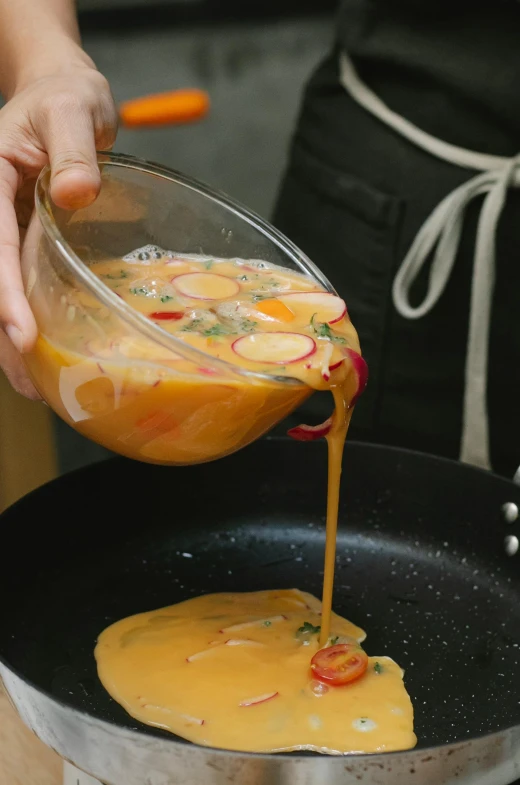 a person pouring something into a frying pan, a pastel, inspired by Kanō Tan'yū, unsplash, melted cheddar, medium close up shot, koi, tall