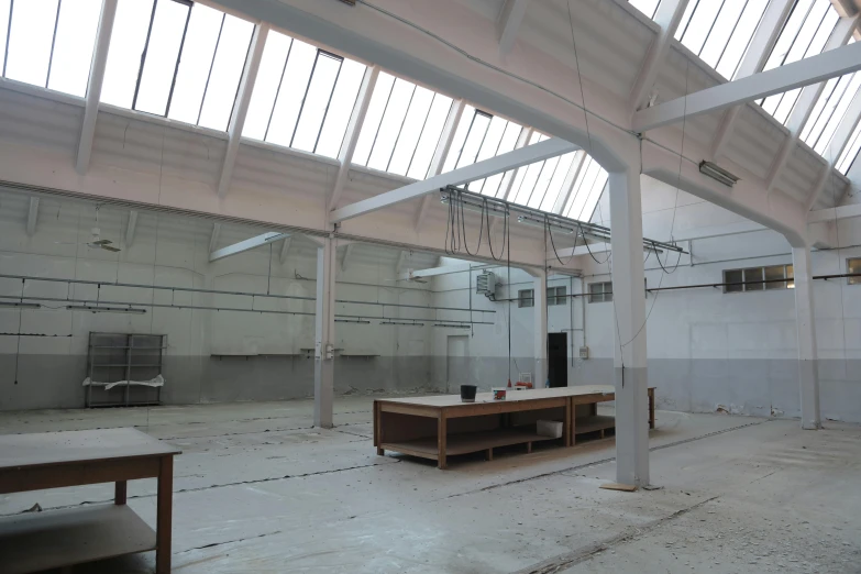 a room that has a bunch of tables in it, a portrait, light and space, factory floor, akitipe studios, full daylight, 256x256