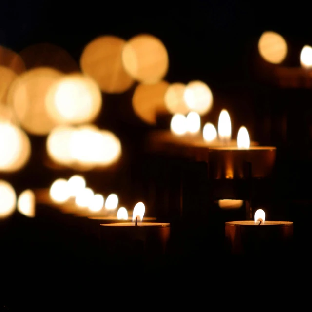 a group of lit candles in a dark room, bokeh. brian spilner, grieving. intricate, instagram post, 15081959 21121991 01012000 4k