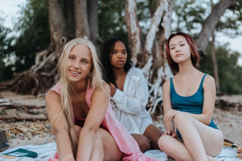 three women sitting on a blanket on the beach, trending on pexels, taned skin, sitting in a tree, avatar image, college girls