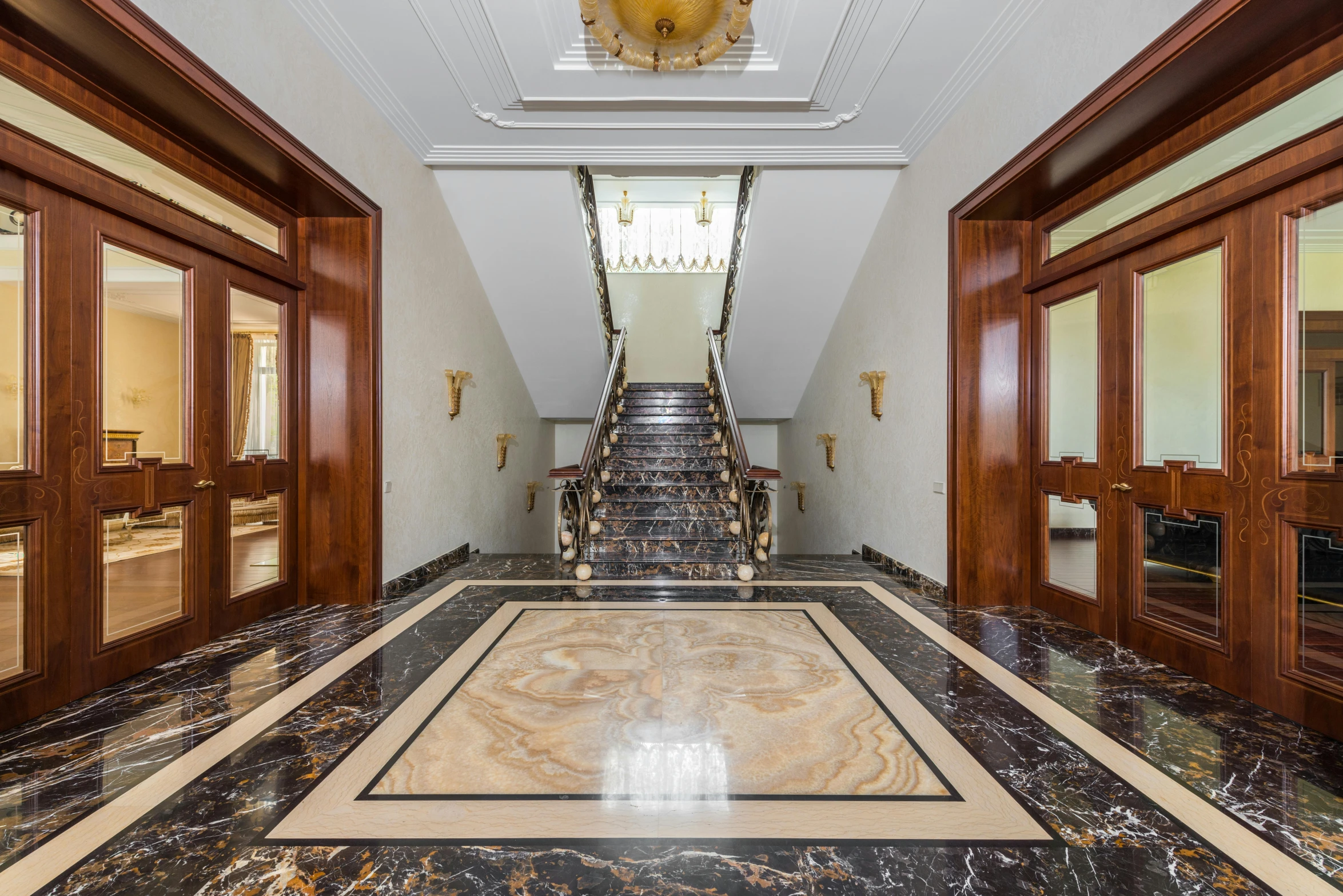 a hallway with a marble floor and a chandelier, an album cover, inspired by Emilio Grau Sala, art nouveau, thumbnail, located in hajibektash complex, professional photo, external staircases