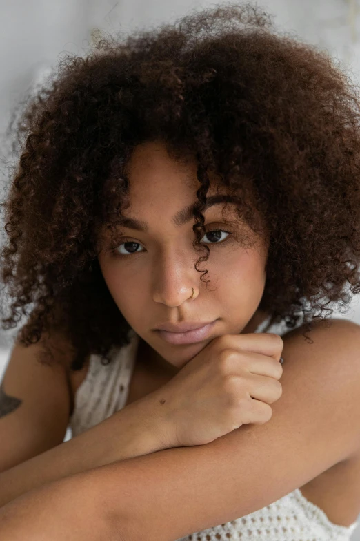 a beautiful young woman sitting on top of a bed, a character portrait, by Daniel Seghers, trending on pexels, ashteroth, close up head shot, promo image, loosely cropped