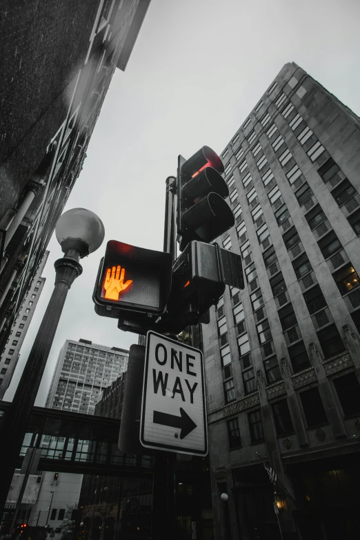 a traffic light that has a one way sign on it, an album cover, by Greg Rutkowski, trending on pexels, high rises, 🚿🗝📝, city on fire, chicago