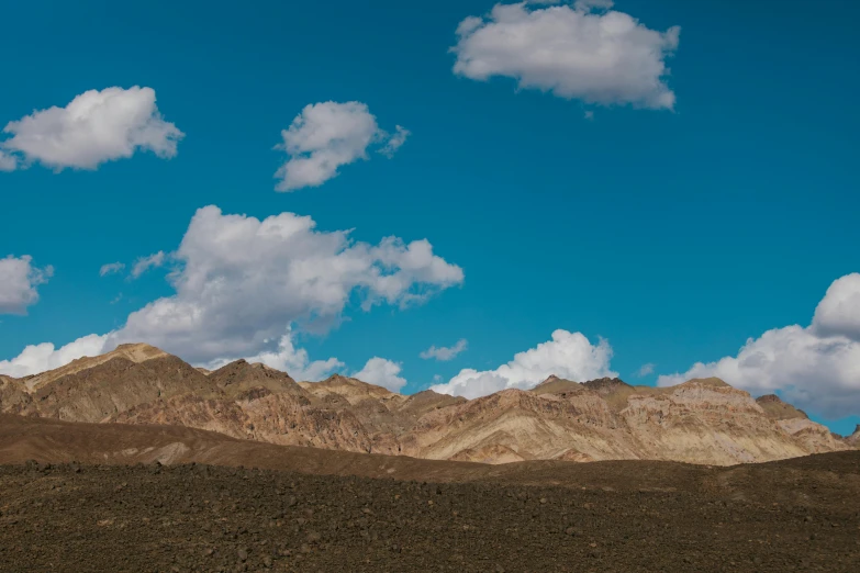 a mountain range with a few clouds in the sky, unsplash contest winner, figuration libre, death valley, summer day, hd footage, large scale photo