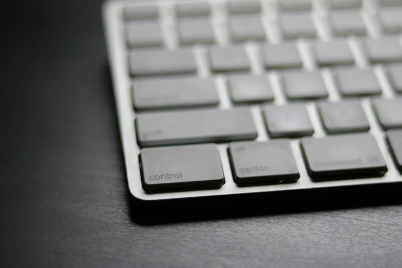 a close up of a keyboard on a table, by Carey Morris, unsplash, computer art, smooth solid concrete, designed in blender, apple, gunmetal grey