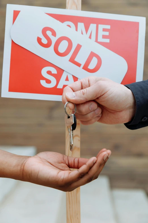 a person handing a sold sign to another person, keys, promo image, square, leaked