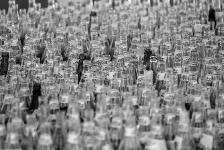 a black and white photo of many glass bottles, a picture, pexels, assemblage, 4k greyscale hd photography, many people, soda, tokujin yoshioka