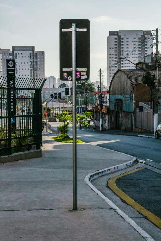 a couple of street signs sitting on the side of a road, by Joze Ciuha, unsplash, sao paulo in the year 2 0 7 0, square, panoramic shot, bus stop