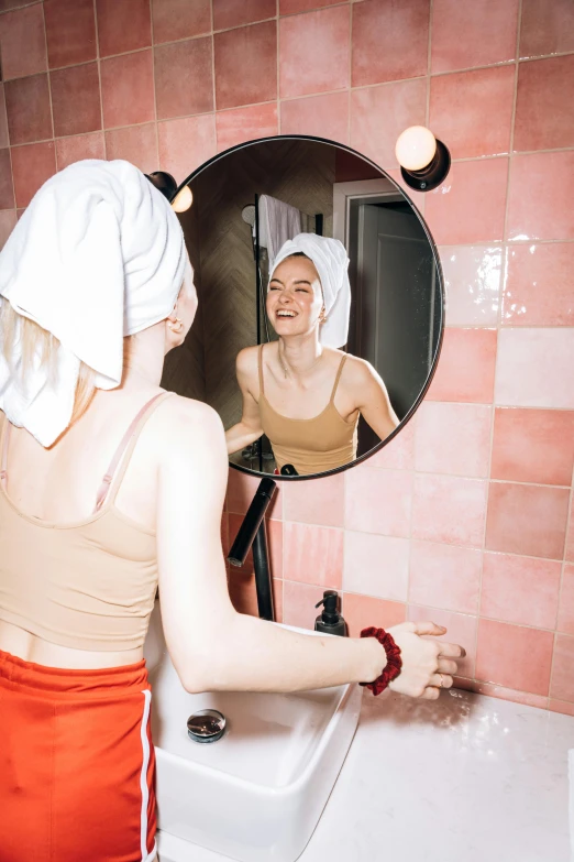 a woman standing in front of a bathroom mirror, by Julia Pishtar, pexels contest winner, renaissance, shower cap, warm skin tone, having fun, instagram post