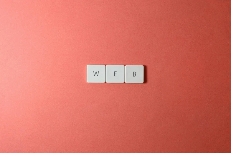 a couple of white tiles sitting on top of a pink surface, web design, weeb, three, sitting on a red button