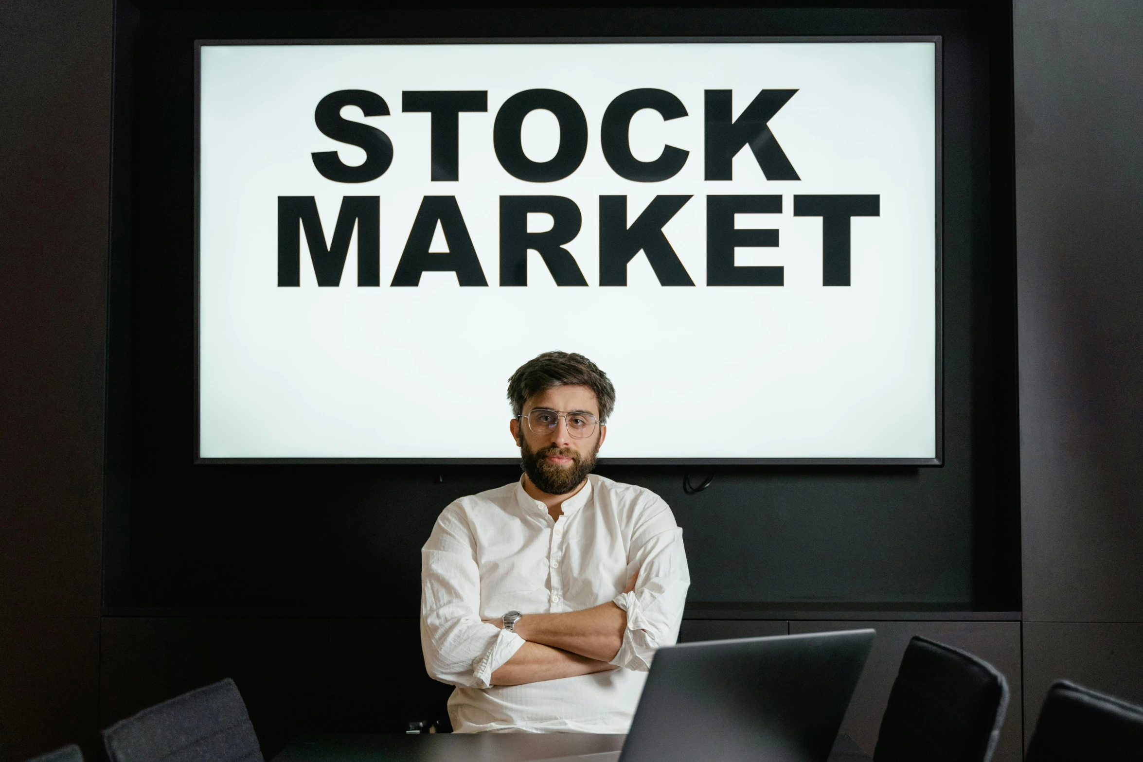 a man sitting at a table with a laptop in front of him, a photo, pexels, renaissance, trading stocks, avatar image, a person standing in front of a, 2 0 7 7