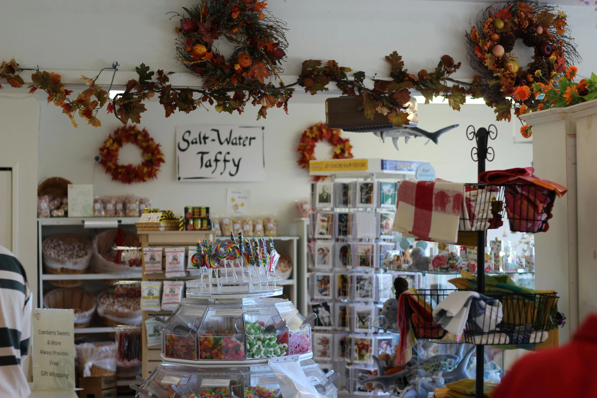 a store filled with lots of different items, by Susy Pilgrim Waters, autumn, sea, gourmet and crafts, medium wide shot