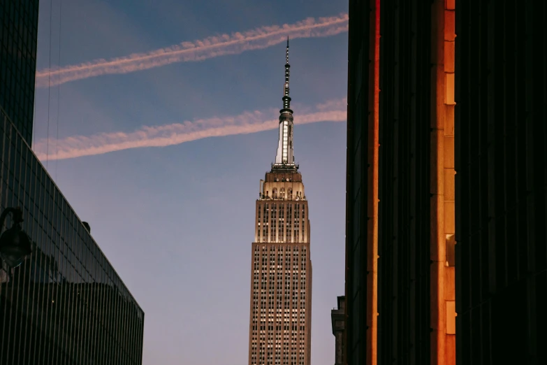 a very tall building sitting in the middle of a city, unsplash contest winner, modernism, empire state building, fan favorite, brown, seen from outside