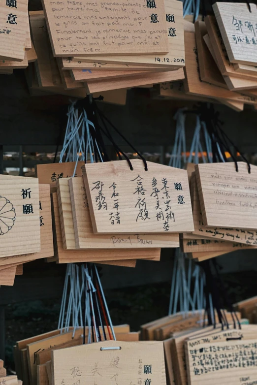 a bunch of wooden plaques with writing on them, unsplash, sōsaku hanga, multiple stories, market