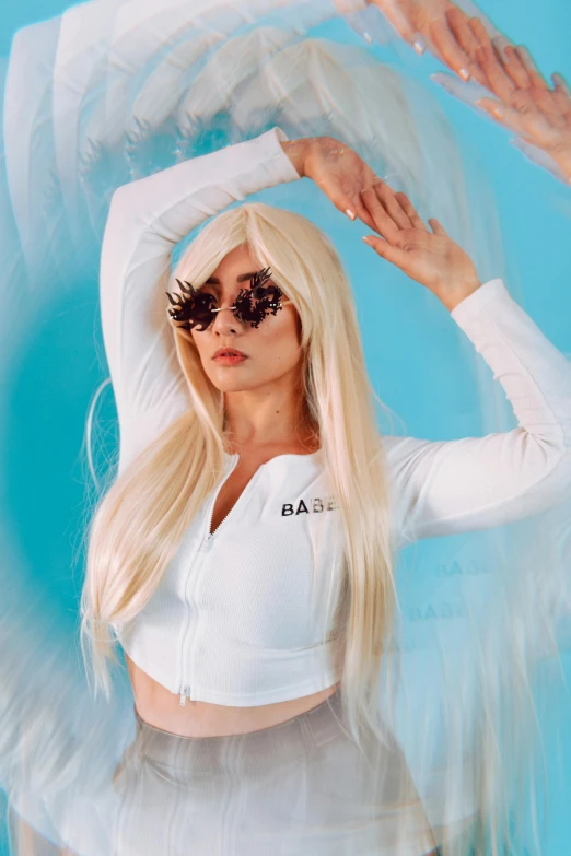 a woman with long blonde hair wearing a white top and skirt, an album cover, inspired by Marie Bashkirtseff, featured on reddit, bad bunny, futuristic glasses lenses, baars, wig
