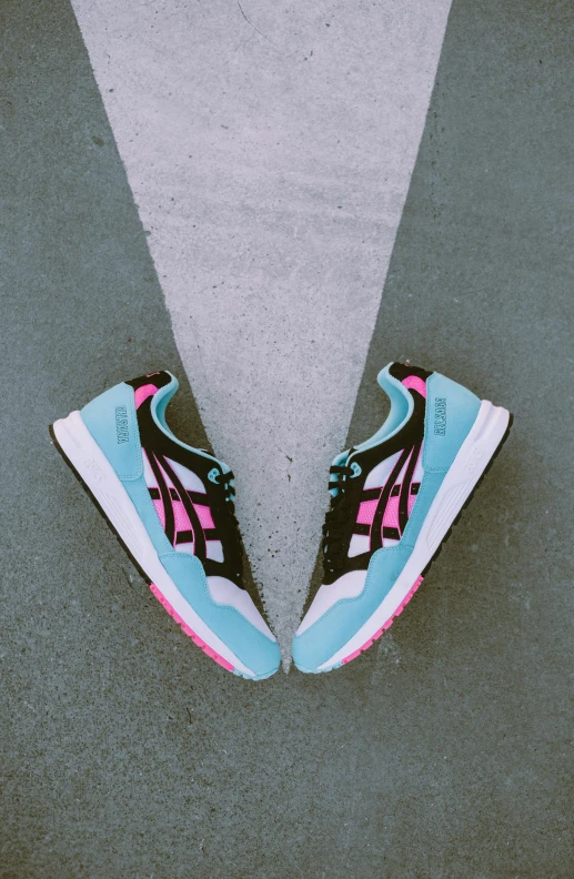 a pair of sneakers sitting on top of a cement floor, by Austin English, blue and pink accents, crosswalk, black and cyan color scheme, japanese collection product