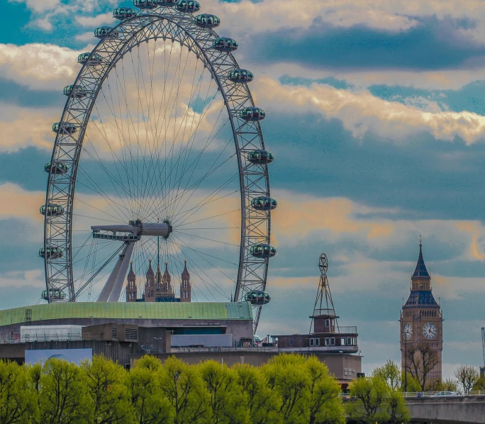 a large ferris wheel sitting on top of a lush green field, big ben, tower bridge, skyline, unsplash photo contest winner