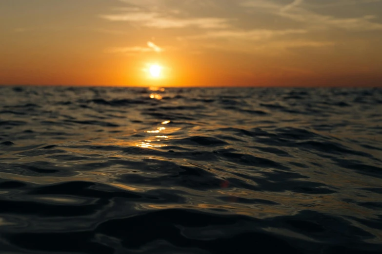 the sun is setting over a body of water, pexels contest winner, water line surface, deep depth, maybe small waves, subtitles