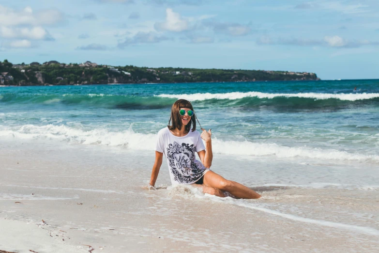 a woman sitting on top of a beach next to the ocean, graphic tees, carribean white sand, all marble, avatar image