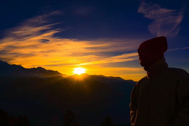 a man standing on top of a mountain at sunset, by Niko Henrichon, pexels contest winner, whistler, avatar image, profile image, warm golden backlit