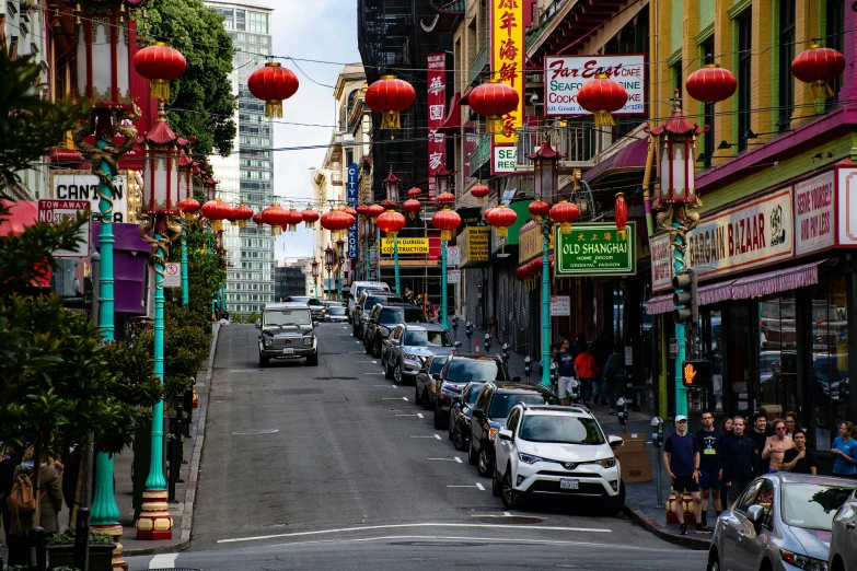 a street filled with lots of traffic next to tall buildings, chinese lanterns, san francisco, background image, square