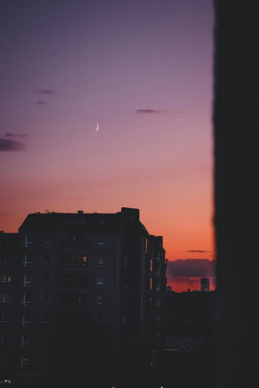 the moon is setting in the sky over a city, a picture, inspired by Elsa Bleda, unsplash contest winner, aestheticism, apartment building on the moon, dusk on jupiter, 2019 trending photo, ✨🕌🌙