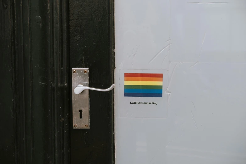 a close up of a door with a rainbow sticker on it, a poster, unsplash, connected to wires, leonora karrington, square sticker, storefront