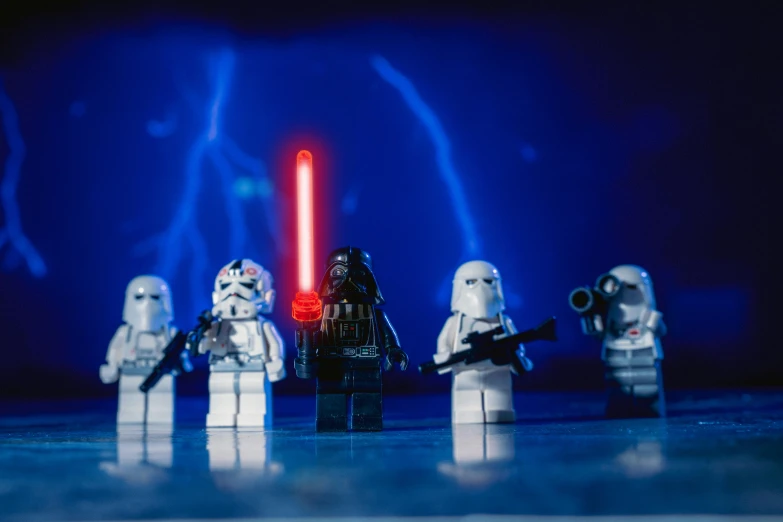 a group of lego star wars figures standing next to each other, a picture, by Sebastian Spreng, pexels contest winner, light and space, extremely moody blue lighting, red leds, imperial military, brand new lego set ( 2 0 2 1 )