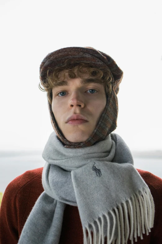 a young man wearing a hat and scarf, an album cover, inspired by Andrew Robertson, skydsgaard, burne hogarth, cast, subreddit / r / whale