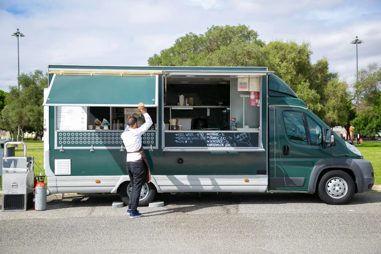 a man standing in front of a food truck, by Lee Loughridge, unsplash, apulia, square, panoramic shot, van