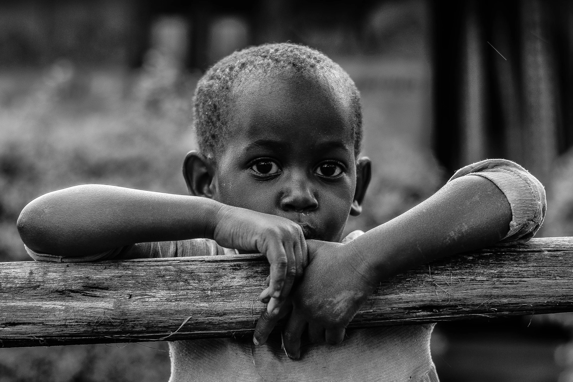 a black and white photo of a young boy, by Joze Ciuha, pexels contest winner, crossed arms, african, 4yr old, photo high definition